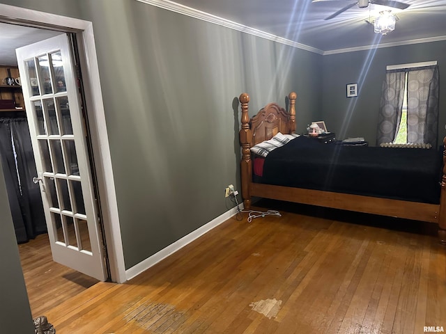 bedroom with crown molding and hardwood / wood-style flooring