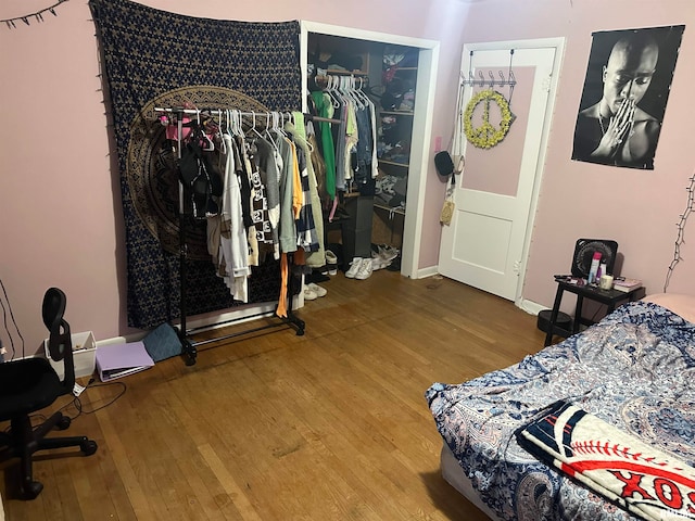 bedroom with a closet and hardwood / wood-style flooring