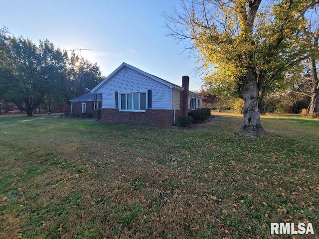 view of side of home featuring a yard