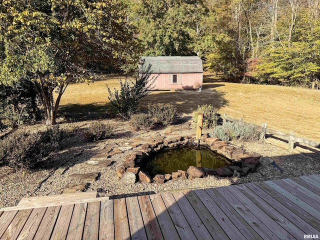 view of yard with a deck and an outbuilding