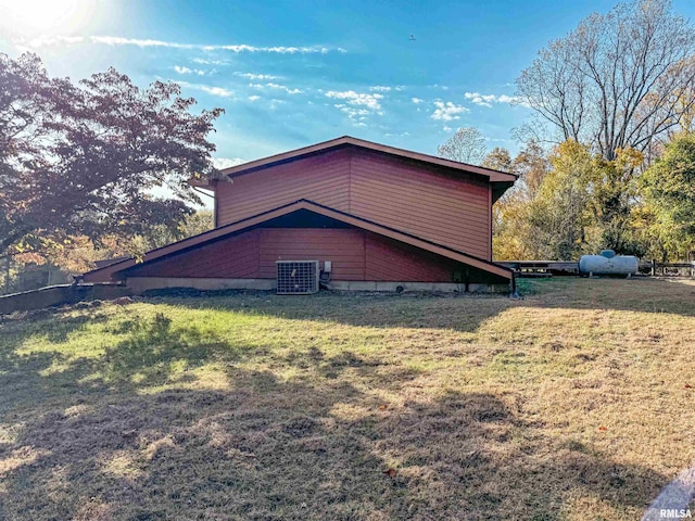 view of home's exterior with a yard and central AC unit