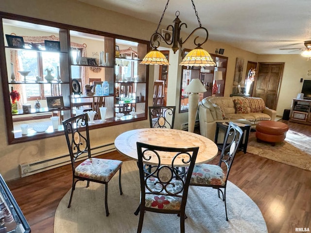 dining area with ceiling fan, hardwood / wood-style flooring, and baseboard heating