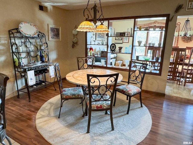 dining room with dark wood-type flooring