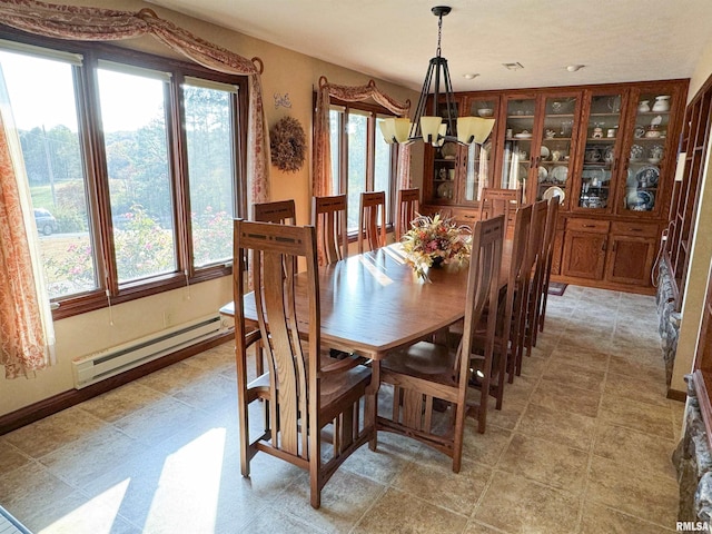 dining room with a notable chandelier and baseboard heating