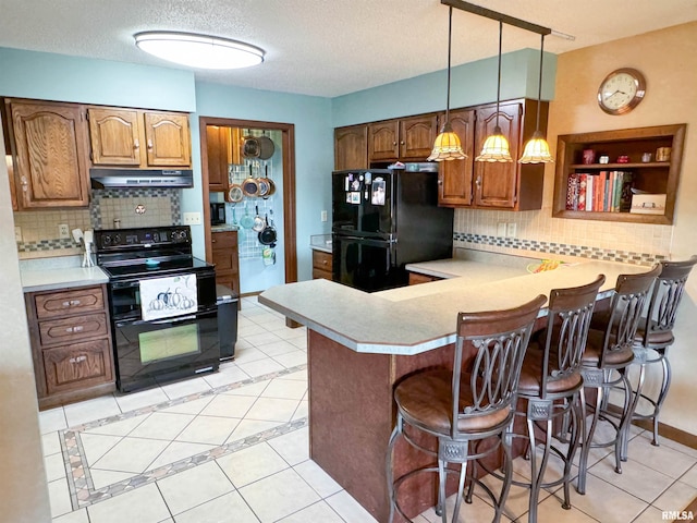 kitchen featuring black appliances, backsplash, a textured ceiling, kitchen peninsula, and pendant lighting