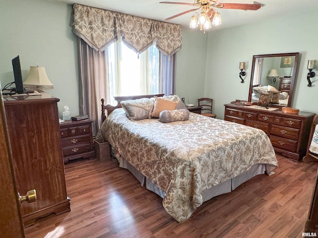 bedroom featuring ceiling fan and dark hardwood / wood-style floors