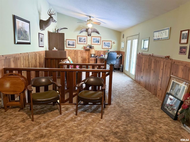 sitting room with carpet floors, ceiling fan, and vaulted ceiling