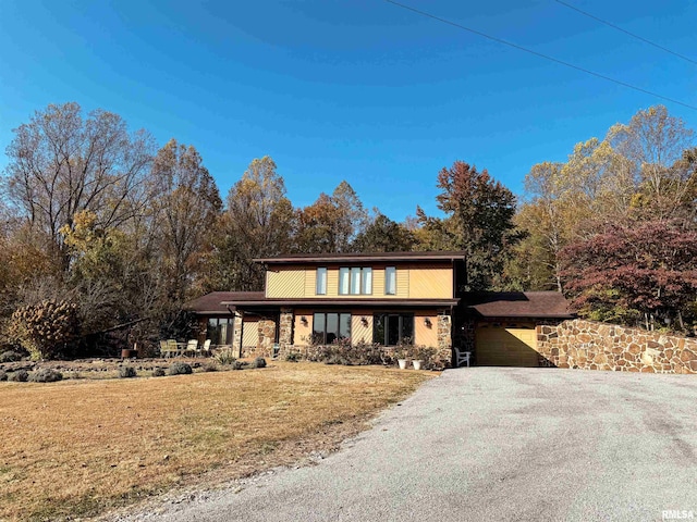 view of front property with a front yard and a garage