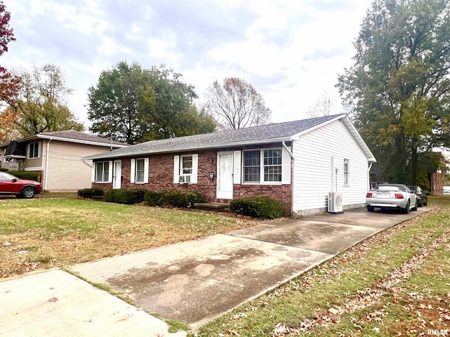 ranch-style house featuring central AC and a front yard