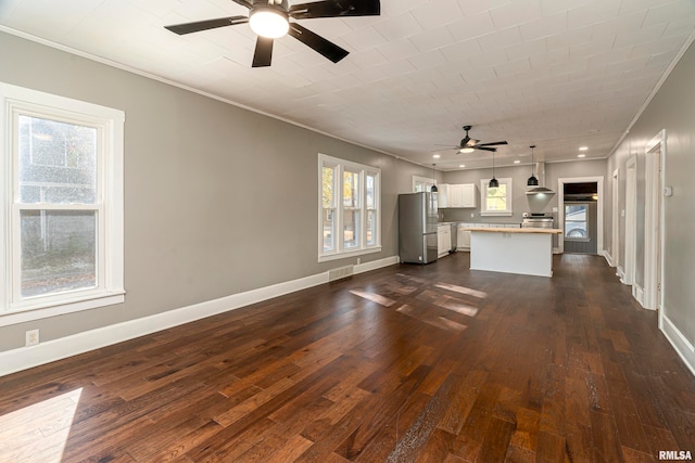 unfurnished living room with crown molding, dark hardwood / wood-style floors, and ceiling fan