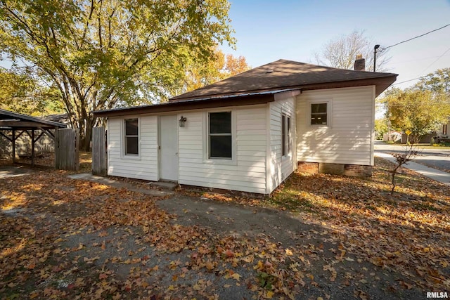 back of property featuring a carport