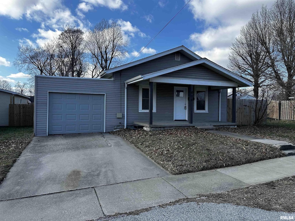 view of front of property with covered porch and a garage