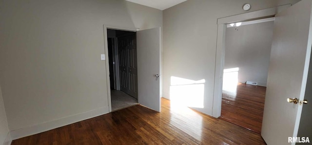 spare room with dark hardwood / wood-style floors