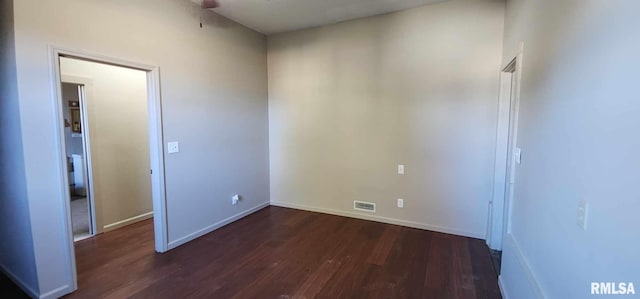 spare room with dark wood-type flooring