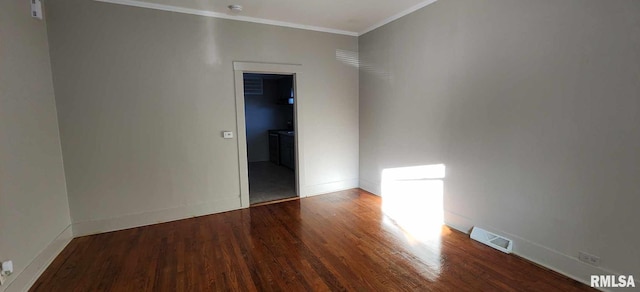 empty room featuring crown molding and hardwood / wood-style flooring