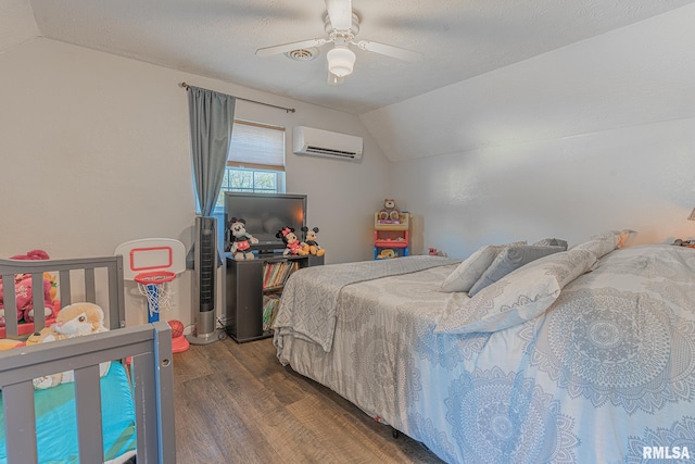 bedroom featuring a wall unit AC, ceiling fan, vaulted ceiling, and dark hardwood / wood-style floors