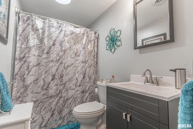 bathroom with vanity, a textured ceiling, toilet, and tile walls