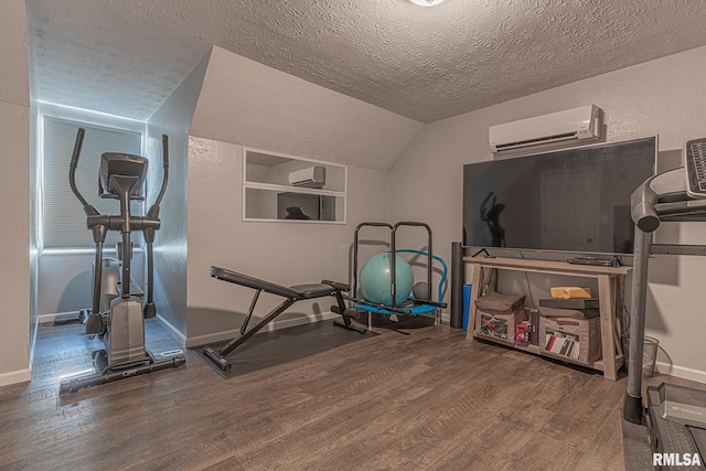 workout area featuring a wall mounted air conditioner, lofted ceiling, a textured ceiling, and wood-type flooring