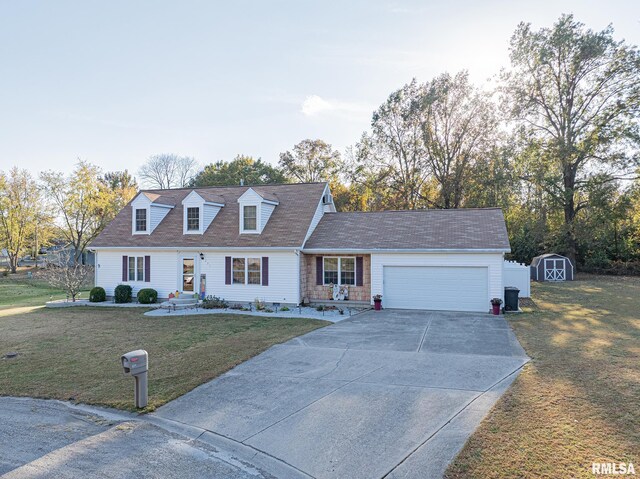 cape cod house featuring a shed, a front lawn, and a garage