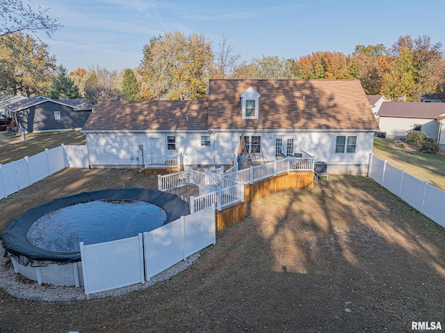 back of house featuring a swimming pool side deck