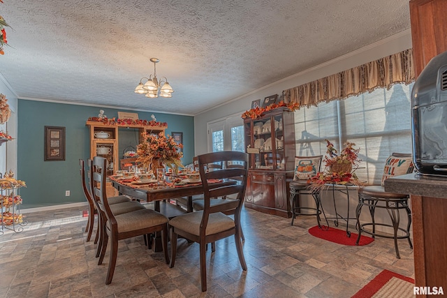 dining area with an inviting chandelier, ornamental molding, a textured ceiling, and a healthy amount of sunlight