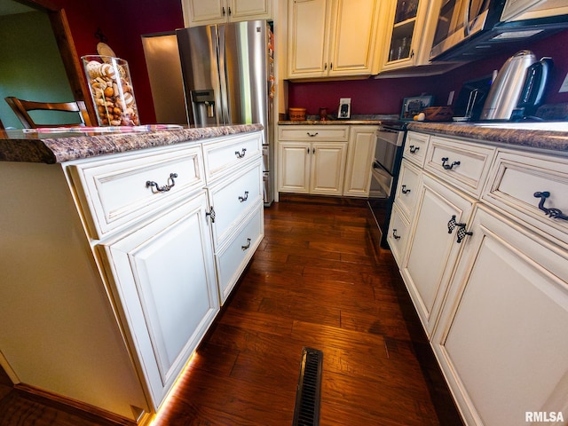 kitchen featuring appliances with stainless steel finishes and dark hardwood / wood-style floors