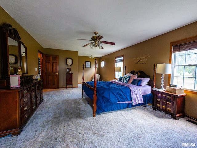 bedroom with a textured ceiling, light colored carpet, and ceiling fan