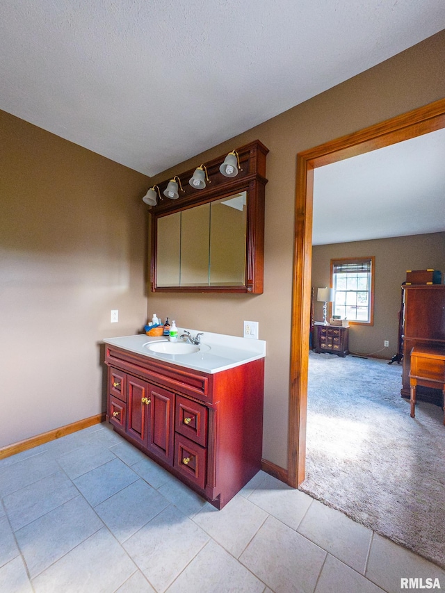 bathroom featuring vanity, tile patterned floors, and a textured ceiling