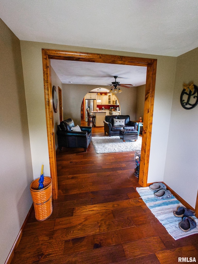 corridor featuring a textured ceiling and hardwood / wood-style floors