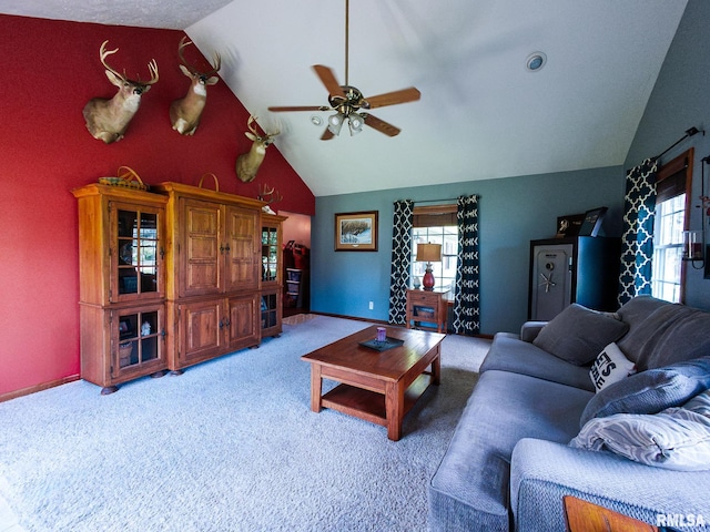 living room with carpet floors, ceiling fan, and vaulted ceiling