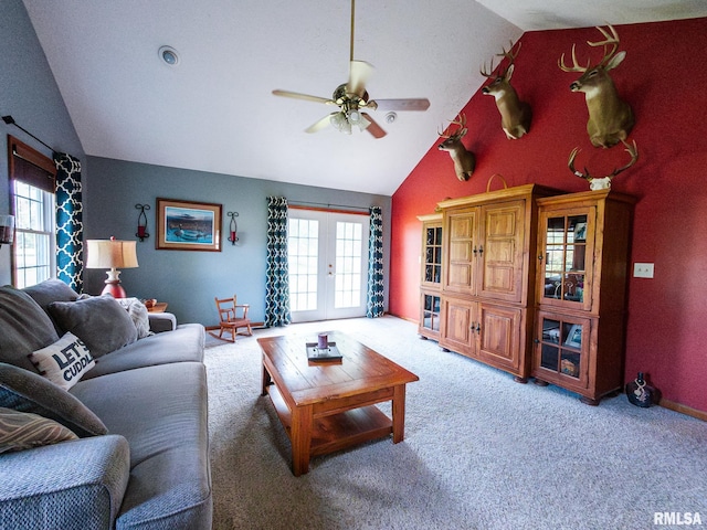 living room with ceiling fan, vaulted ceiling, and plenty of natural light