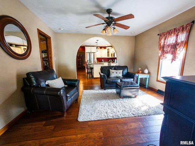 living room with dark hardwood / wood-style floors and ceiling fan