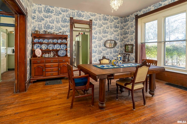 dining area featuring an inviting chandelier and hardwood / wood-style floors