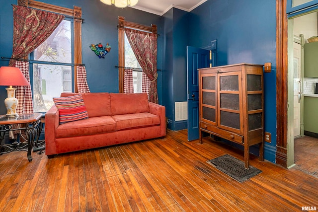 living room with crown molding and wood-type flooring