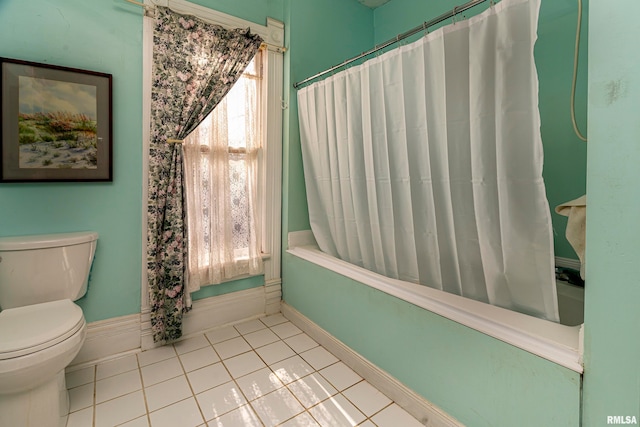 bathroom with shower / bath combo with shower curtain, toilet, and tile patterned flooring