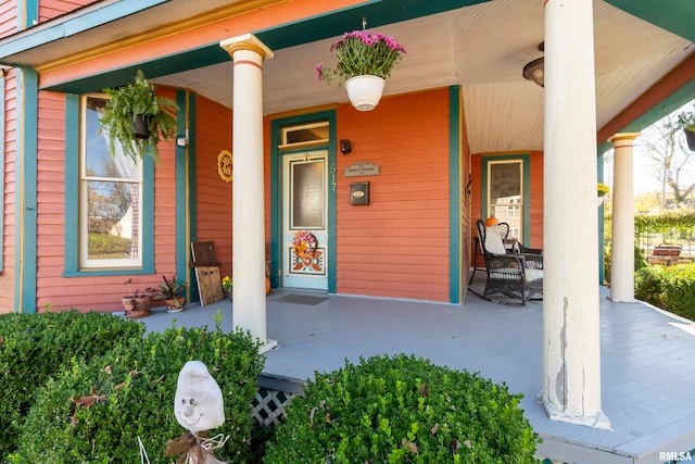 view of exterior entry with a porch