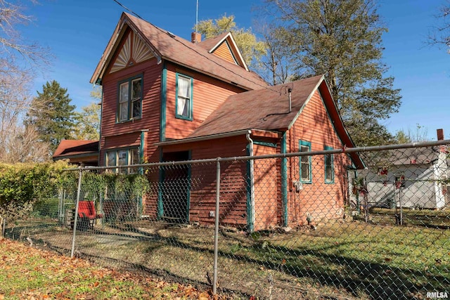 back of property featuring a lawn