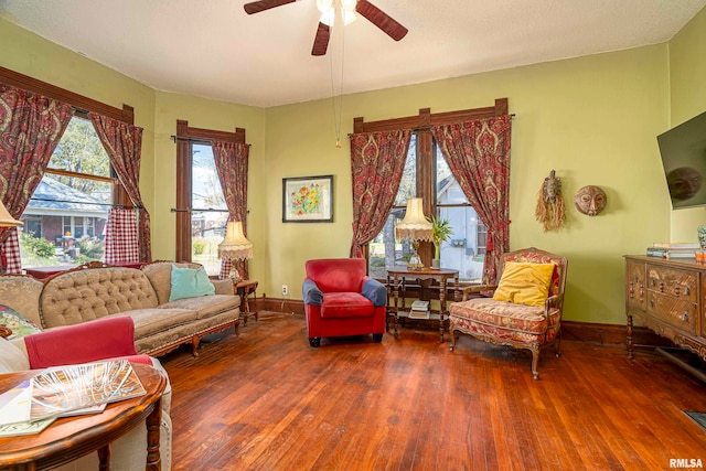 living room with ceiling fan and dark hardwood / wood-style flooring