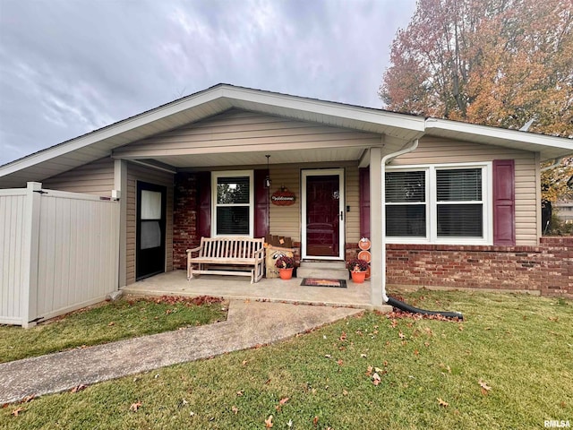 view of front of property with a porch and a front yard