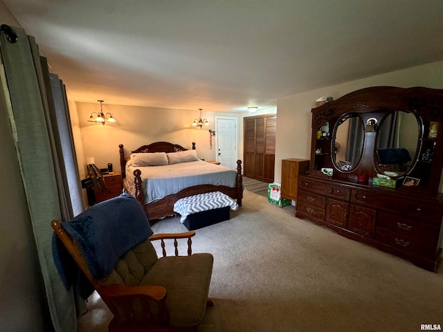 bedroom with an inviting chandelier and carpet floors