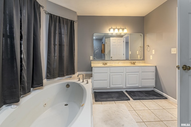 bathroom featuring tile patterned flooring, a bathing tub, and vanity