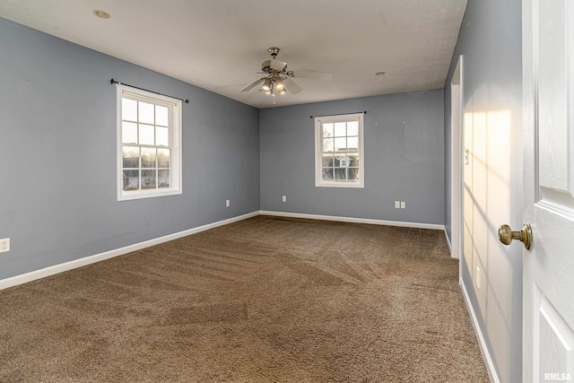 unfurnished room with ceiling fan and carpet