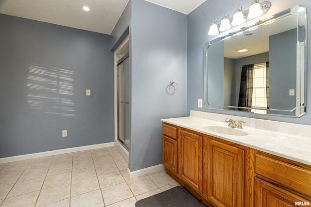 bathroom with vanity, a shower with shower door, and tile patterned flooring