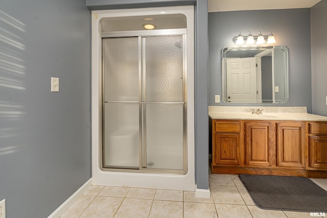 bathroom featuring an enclosed shower, vanity, and tile patterned floors