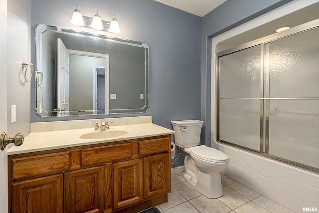 full bathroom with vanity, tile patterned floors, shower / bath combination with glass door, and toilet