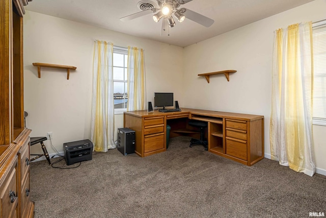 office space featuring dark carpet and ceiling fan