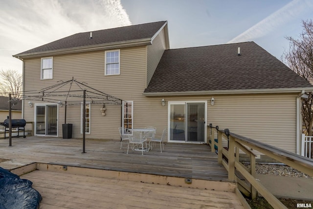 back of house with a wooden deck