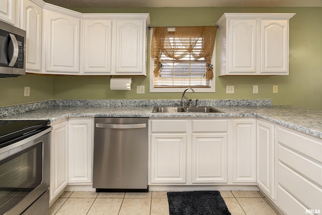 kitchen with white cabinetry, appliances with stainless steel finishes, and sink