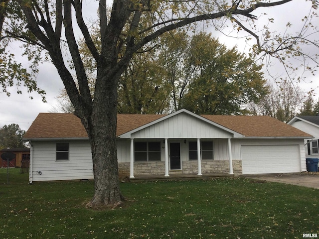 ranch-style home with a porch, a front lawn, and a garage