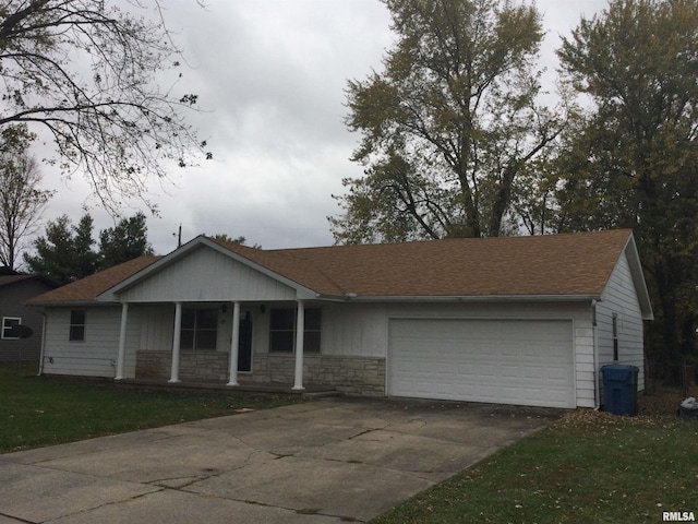 ranch-style home featuring covered porch, a front lawn, and a garage